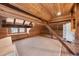 Large attic featuring wood ceiling, exposed beams, and natural light at 701 S Edison Ave, Tampa, FL 33606