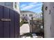 Backyard view from behind a gate showing a pool, landscaping, and house exterior at 701 S Edison Ave, Tampa, FL 33606