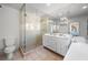 Bright bathroom featuring a glass-enclosed shower, double vanity, and a freestanding bathtub at 701 S Edison Ave, Tampa, FL 33606