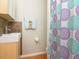 Modern bathroom vanity with a blue and purple decorative shower curtain at 701 S Edison Ave, Tampa, FL 33606