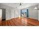 Bright bedroom with hardwood floors, ceiling fan, natural light from the window and a door at 701 S Edison Ave, Tampa, FL 33606