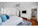 Bedroom featuring hardwood floors, ceiling fan, large windows, and ensuite bathroom at 701 S Edison Ave, Tampa, FL 33606