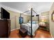 Comfortable bedroom with a four-poster bed, dark wood accents, and a neutral palette at 701 S Edison Ave, Tampa, FL 33606