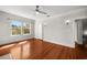 Bright bedroom boasts hardwood floors, ceiling fan, and natural light from the windows at 701 S Edison Ave, Tampa, FL 33606
