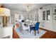 Spacious dining room with a glass table, blue chairs, and a view into the living room and kitchen at 701 S Edison Ave, Tampa, FL 33606