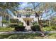 Beautiful two-story home featuring a lush front lawn, trimmed bushes, and an inviting covered entryway at 701 S Edison Ave, Tampa, FL 33606