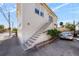 Charming exterior view of a white two-story house with stairs leading to the second level at 701 S Edison Ave, Tampa, FL 33606