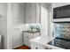 Well-lit kitchen with a stainless steel microwave, granite countertops, and subway tile backsplash at 701 S Edison Ave, Tampa, FL 33606
