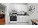 Bright kitchen with white cabinets, marbled floors and a stainless steel sink at 701 S Edison Ave, Tampa, FL 33606
