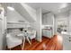 Cozy kitchen nook with a glass table, white chairs, and built-in shelving for storage and decor at 701 S Edison Ave, Tampa, FL 33606