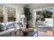 Cozy living room showcasing hardwood floors, a comfortable sofa, and a picturesque view of the outdoor pool at 701 S Edison Ave, Tampa, FL 33606