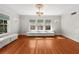 Bright living room featuring a chandelier, hardwood floors, and windows with built-in benches at 701 S Edison Ave, Tampa, FL 33606