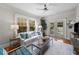 Bright living room boasts hardwood floors, white walls and views of the private outdoor pool and entertaining area at 701 S Edison Ave, Tampa, FL 33606