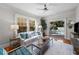Bright living room boasts hardwood floors, white walls and views of the private outdoor pool and entertaining area at 701 S Edison Ave, Tampa, FL 33606