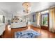 Bright living room with hardwood floors, fireplace, a modern sofa, and views of the outdoors at 701 S Edison Ave, Tampa, FL 33606