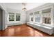 Bright living room with hardwood floors, chandelier, white trim, and windows with built-in benches at 701 S Edison Ave, Tampa, FL 33606