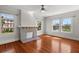 Cozy living room features a brick fireplace, hardwood floors and bright windows with views at 701 S Edison Ave, Tampa, FL 33606