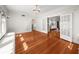 Bright living room with hardwood floors, chandelier, and white trim, open to an adjacent room via french doors at 701 S Edison Ave, Tampa, FL 33606
