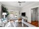 Cozy living room featuring hardwood floors, and french doors leading to the pool and outdoor entertaining area at 701 S Edison Ave, Tampa, FL 33606