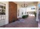 Brick patio with brick accent wall, white trim, and hanging chandelier at 701 S Edison Ave, Tampa, FL 33606
