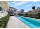 Backyard pool with travertine tile decking and lush landscaping surrounding for ultimate privacy at 701 S Edison Ave, Tampa, FL 33606