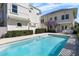Sparkling pool surrounded by a travertine patio and lush landscaping offers a private retreat at 701 S Edison Ave, Tampa, FL 33606