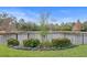 A decorative flower bed with a black aluminum fence backs to a pond at 7820 Marsh Pointe Dr, Tampa, FL 33635