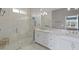 A luxurious bathroom with marble countertop vanity, glass shower and natural light, perfect for relaxation at 7820 Marsh Pointe Dr, Tampa, FL 33635