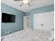 This bedroom features a TV, ceiling fan, and closet at 7820 Marsh Pointe Dr, Tampa, FL 33635