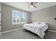 Bedroom features two windows with plantation shutters and gray carpet at 7820 Marsh Pointe Dr, Tampa, FL 33635