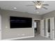 Spacious bedroom featuring neutral walls, a ceiling fan, and doorways to a bathroom and another room at 7820 Marsh Pointe Dr, Tampa, FL 33635