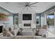 Bright living room with fireplace, ceiling fan, and view of pool through sliding glass door at 7820 Marsh Pointe Dr, Tampa, FL 33635