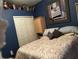 Cozy bedroom featuring blue walls, carpet, and closet storage space at 8214 Tabbystone Pl, Bradenton, FL 34201