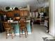 Open-concept kitchen with breakfast bar seating flows into the living area at 8214 Tabbystone Pl, Bradenton, FL 34201