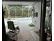 View of the lanai from inside, showing the pool, seating area, and screened enclosure at 8214 Tabbystone Pl, Bradenton, FL 34201