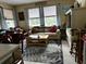 Inviting living room with comfortable seating, hardwood flooring, and large windows at 8214 Tabbystone Pl, Bradenton, FL 34201