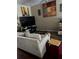 Comfortable living room featuring a plush sofa, artwork, and entertainment area at 8214 Tabbystone Pl, Bradenton, FL 34201