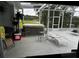 Covered patio area featuring a hot tub, lounge chairs, and views of the surrounding scenery at 8214 Tabbystone Pl, Bradenton, FL 34201