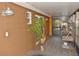 Enclosed porch with brown brick wall, gray tile floor, and potted plant, featuring a bird cage at 8708 Orient Ne Way, St Petersburg, FL 33702