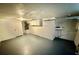 Basement area with storage cabinets, utility hookups, and finished floors at 8708 Robilina Rd, Port Richey, FL 34668
