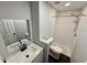 This bathroom features modern fixtures, a vanity, and a tiled shower with glass door at 8708 Robilina Rd, Port Richey, FL 34668