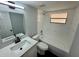 Bathroom featuring modern vanity, shower-tub combo and a window bringing in lots of natural light at 8708 Robilina Rd, Port Richey, FL 34668