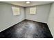 Bright bedroom featuring sleek tile flooring, neutral paint and dual windows at 8708 Robilina Rd, Port Richey, FL 34668