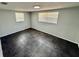 Well-lit bedroom featuring sleek tile flooring, neutral paint and dual windows at 8708 Robilina Rd, Port Richey, FL 34668