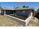 View of home with landscaping, showcasing the stone and cement block front yard at 8708 Robilina Rd, Port Richey, FL 34668
