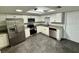 Modern kitchen featuring stainless steel appliances, white cabinetry and granite countertops at 8708 Robilina Rd, Port Richey, FL 34668