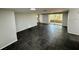 Spacious living room with sleek tile flooring, sliding glass doors, and neutral paint at 8708 Robilina Rd, Port Richey, FL 34668