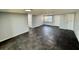 Spacious living room with durable dark tile flooring, neutral paint, and ample natural light at 8708 Robilina Rd, Port Richey, FL 34668