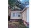 Beige, one-story home with vinyl siding, and tree overshadowing the house at 902 Estelle Ave, Brandon, FL 33511