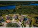 Aerial view of homes in a cul-de-sac, next to a pond, showing a Gathering-friendly neighborhood at 9211 Seeger Ln, Land O Lakes, FL 34638